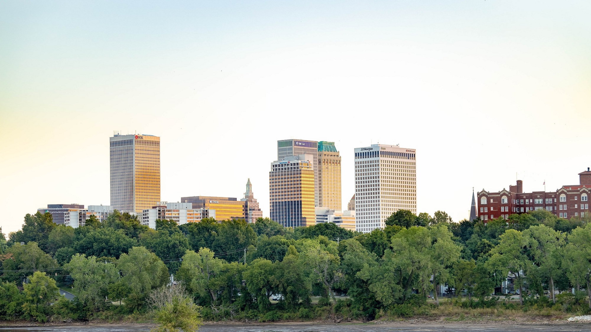 Couple sitting together on couch looking at laptop